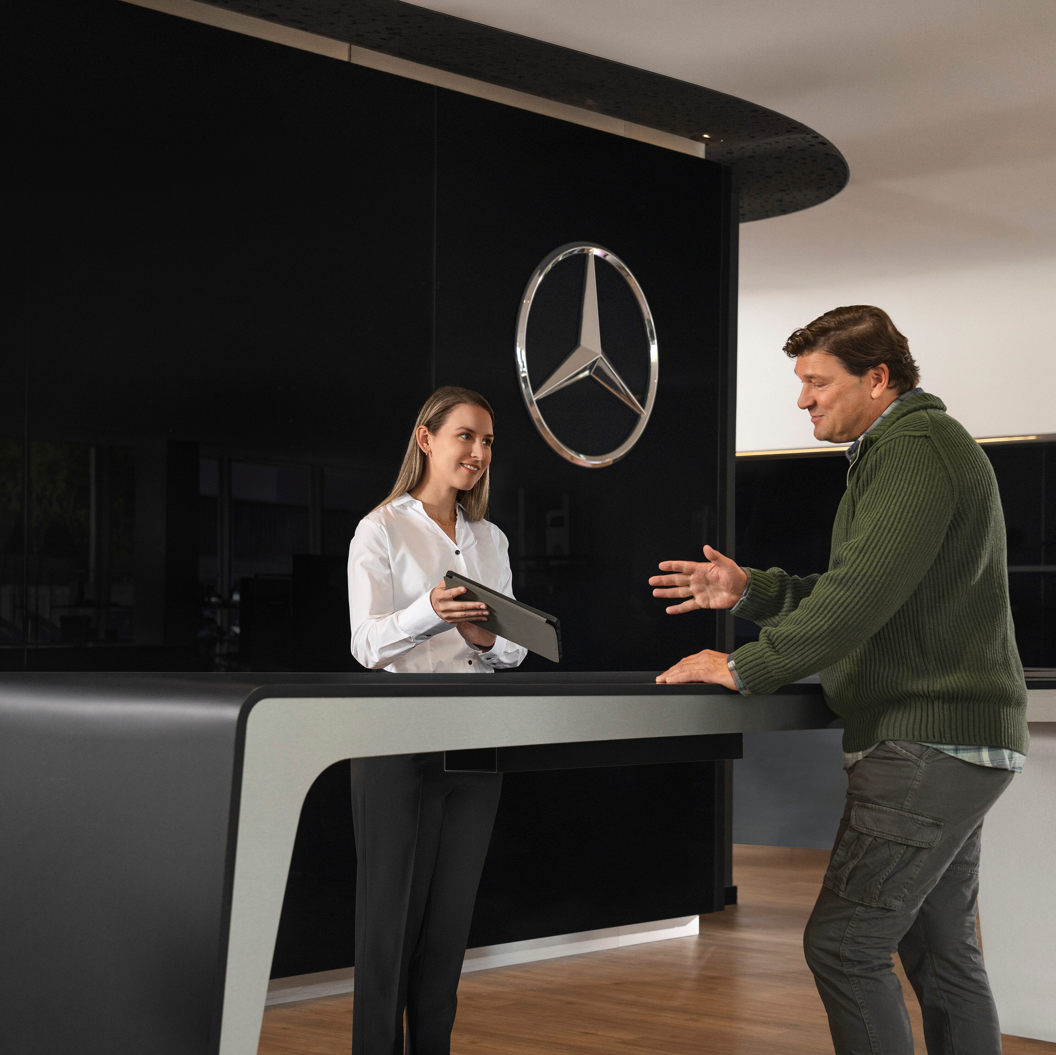 A Mercedes-Benz representative speaking to a customer